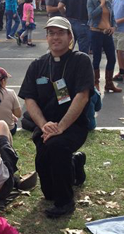 Rev. Ramon Decaen (’96) waits for the Popemobile to pass by 