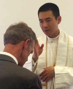 Fr. Jacob offers a blessing to Director of Gift Planning Tom