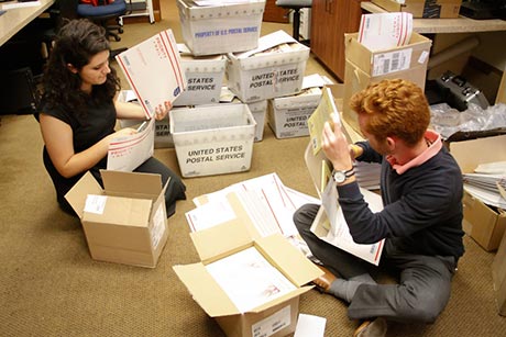 Admissions staff assemble the packets.