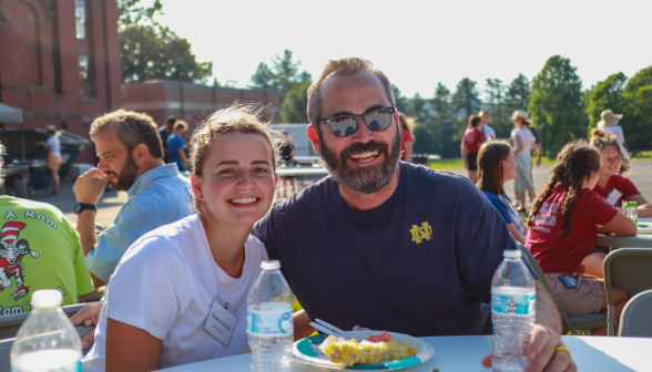 A student with her father at the BBQ