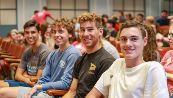 Students smile for the camera in the Dolben Auditorium