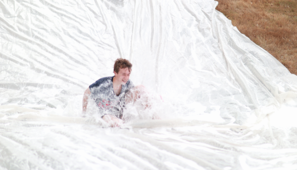 A student goes down the slide sitting