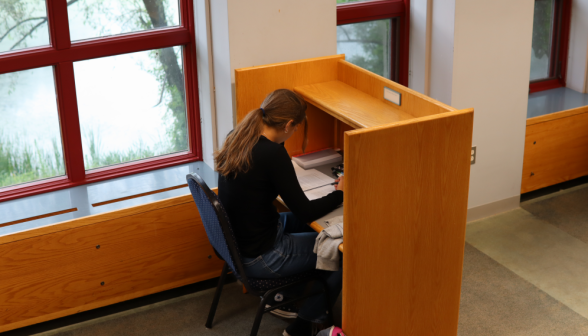 A student studies at an individual desk