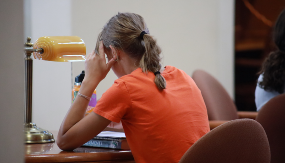 A student studies at a desk