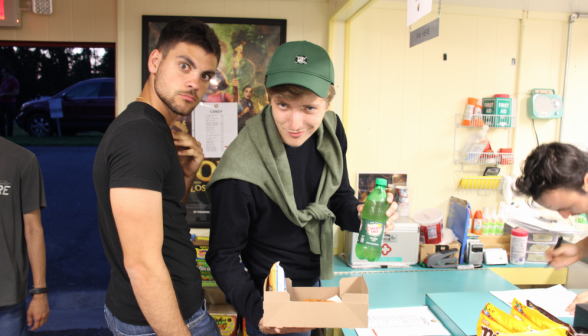 Two prefects pose with food in the snack shop