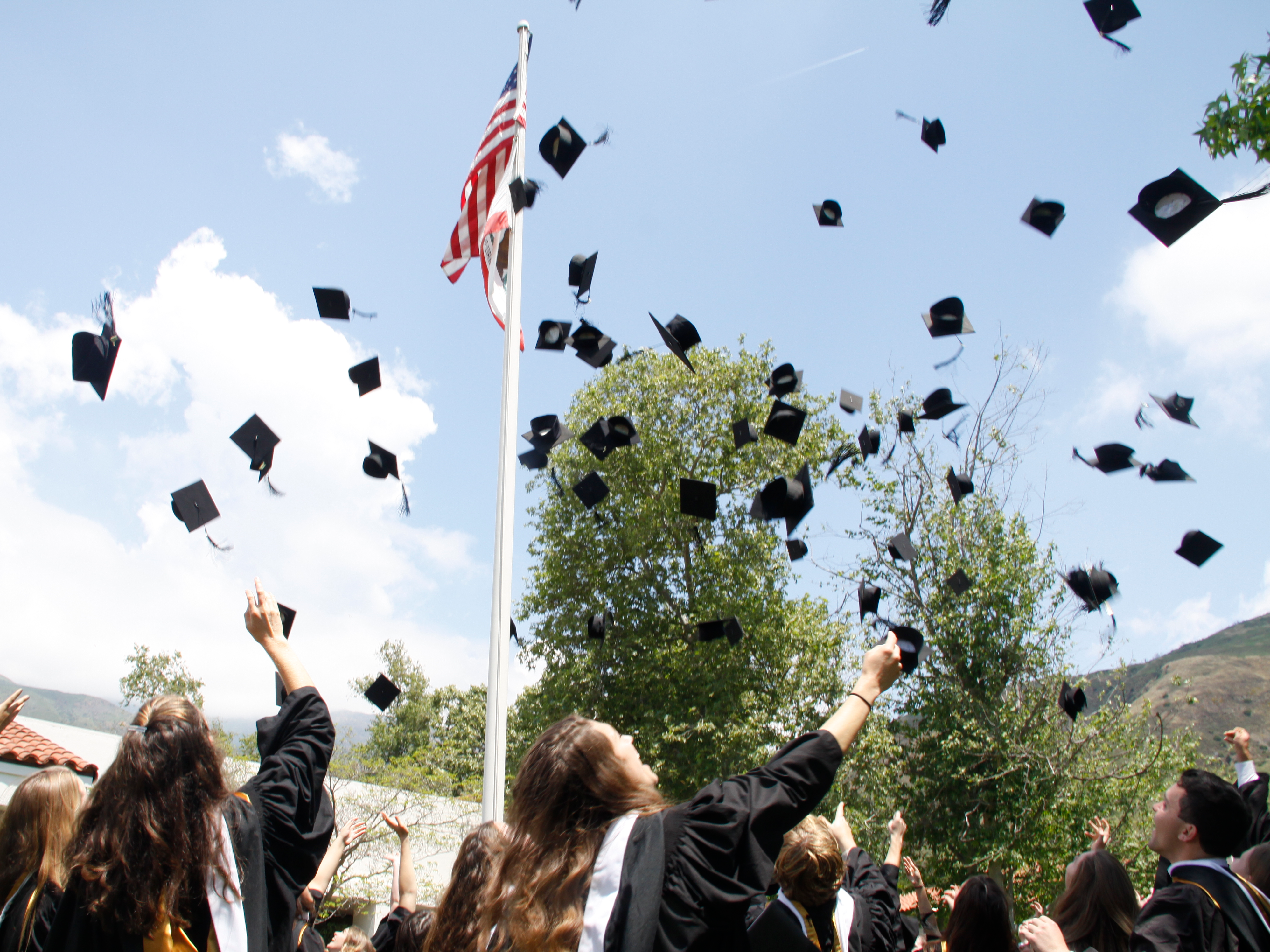 Students toss their mortarboards at Commencement