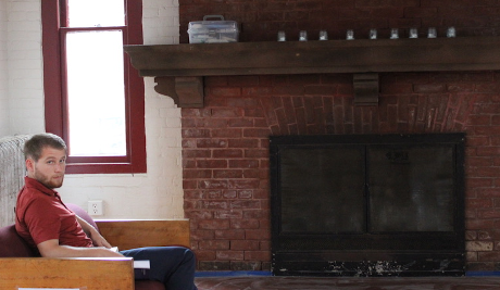 A student reads by the Tracy Student Center fireplace