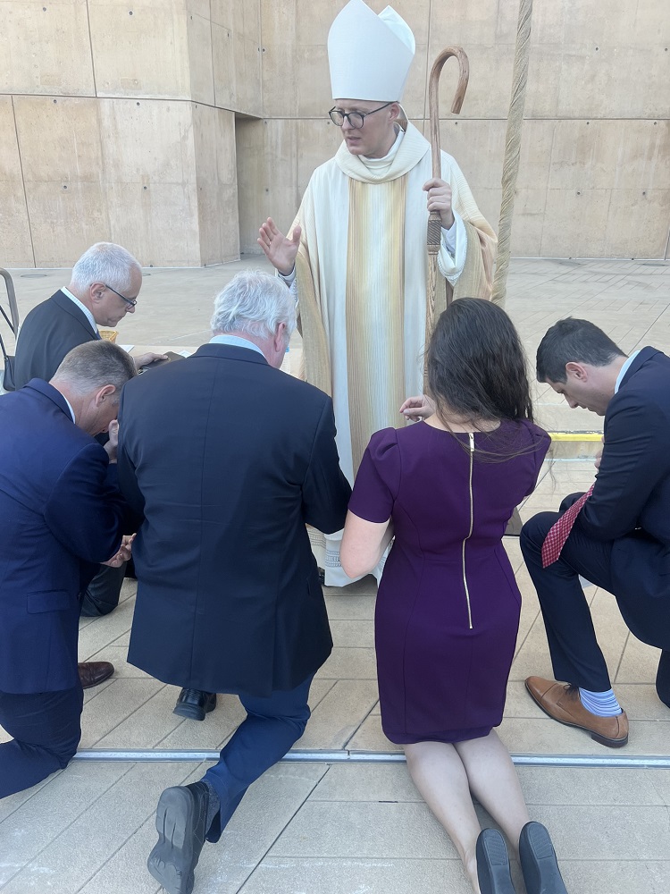 Bishop Szkredka blesses some of the california staff