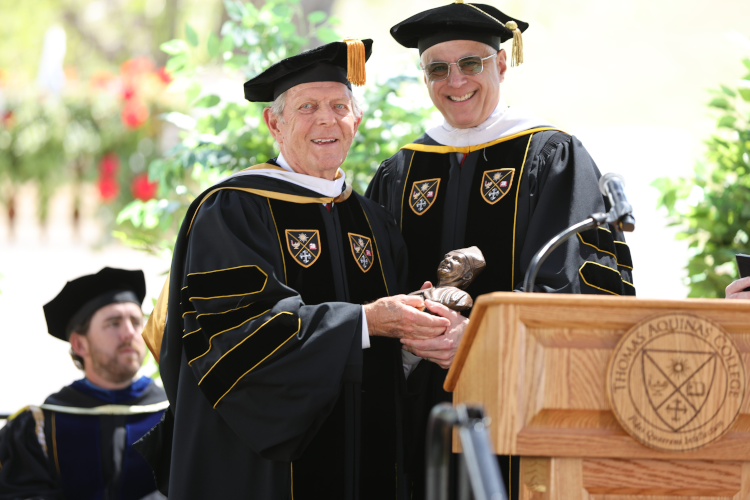 Governor Emeritus Milton “Bud” Daily receives a bust of St. Albert the Great from Chairman of the Board of Governors Scott Turicchi