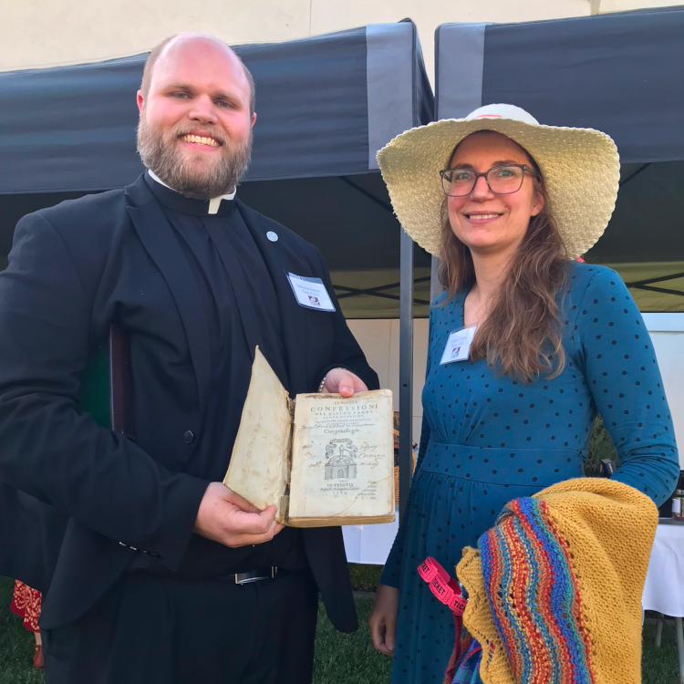 Rev. Mr. Nathaniel Roberts (’13) presents a 500-year-old edition of St. Augustine’s Confessions to TAC Librarian Richena Curphy at the West Coast Alumni Dinner.