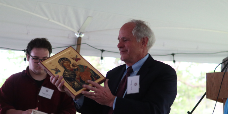 In recognition of his service to the New England campus, Dr. Kaiser receives an icon of Our Mother of Perpetual Help on the eve of Commencement 2022.