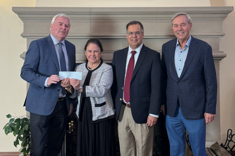 Maureen Rawlinson, a trustee of the Fritz B. Burns Foundation, presents a check for $7 million to President Paul J. O’Reilly, Vice President for Advancement John J. Goyette, and Dieter Huckestein, a member of the Thomas Aquinas College Board of Governors.