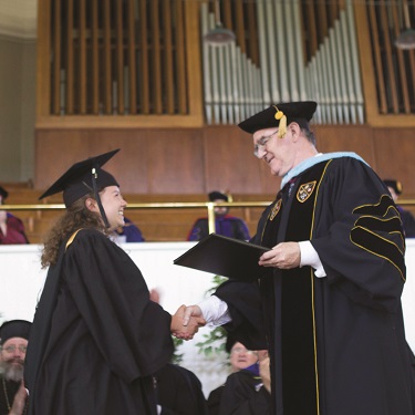 Mr. Flatley presents Magdalena Huckins ('23) with her diploma