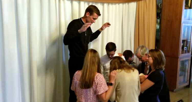 Fr. Allen blesses his parents and siblings