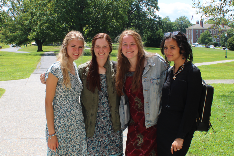 Three students and a prefect pose for a photo