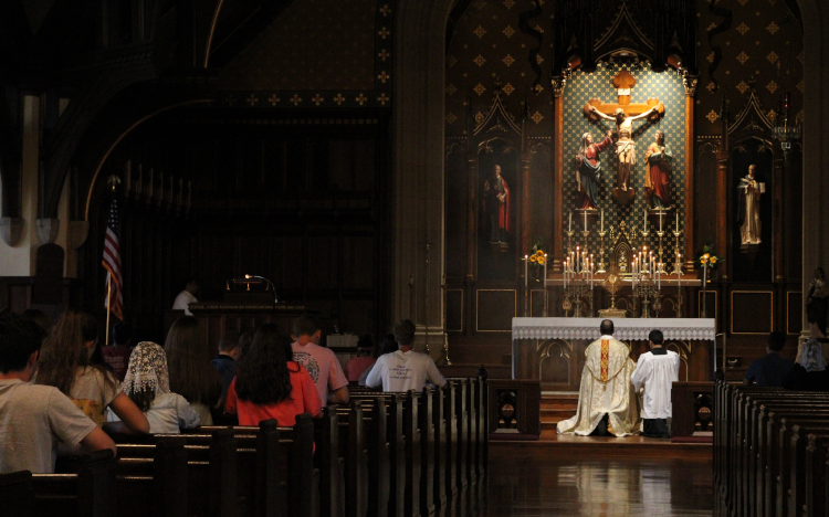 Students adore the exposed Sacrament