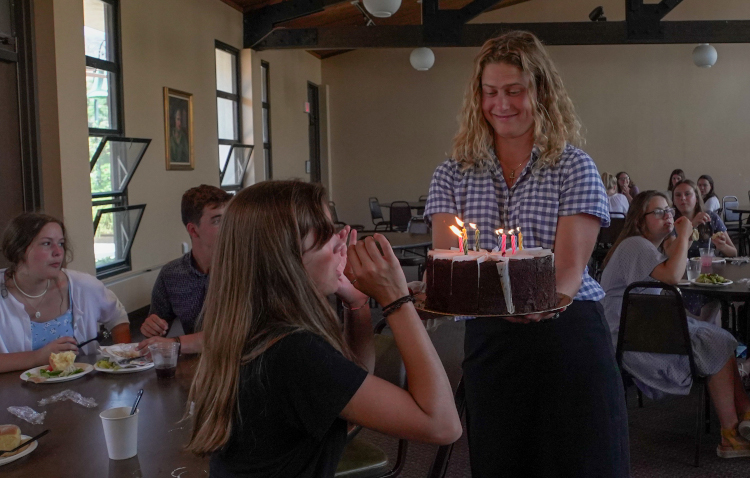 A student receives a birthday cake