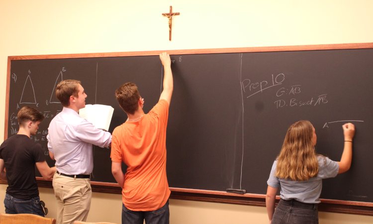 Students practice their propositions on the blackboard