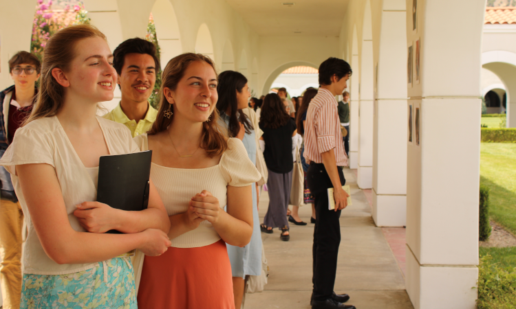 Students admire artworks posted on the pillars of the arcade