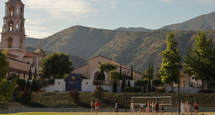 Students congregate on the volleyball court