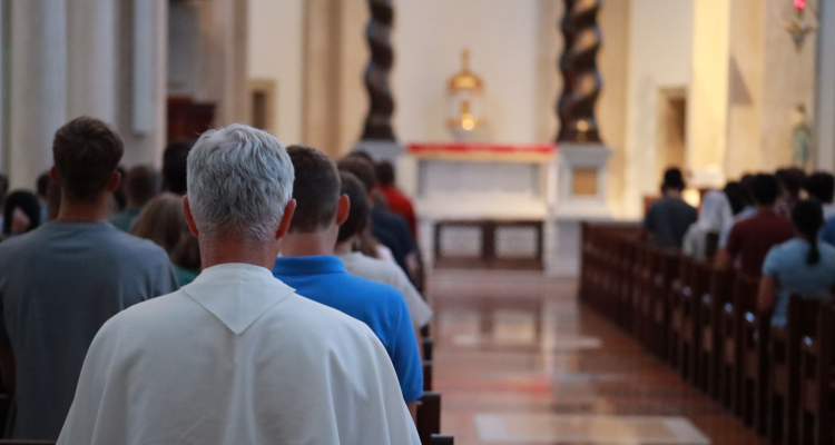 Fr. Walshe prays with the students