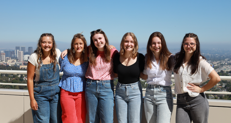 Six pose together at the Getty