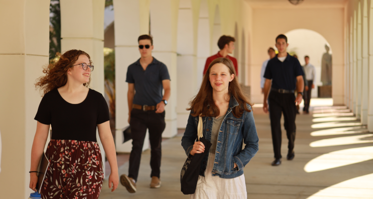 Several walk under the arcade