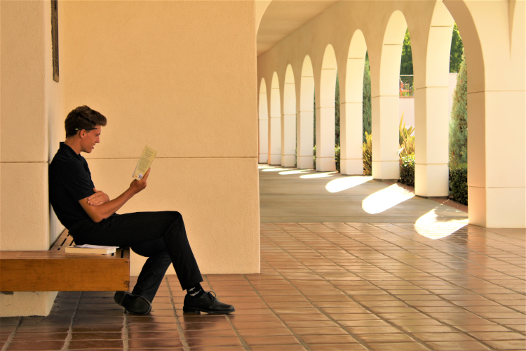 Students walk across academic quadrangle