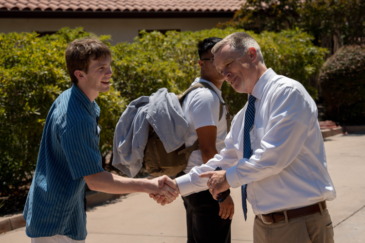 Mr. Daly welcomes a student