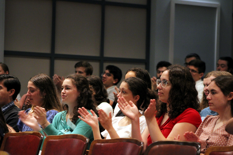 Students applaud at panel