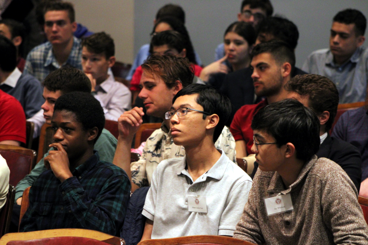 Students applaud at panel