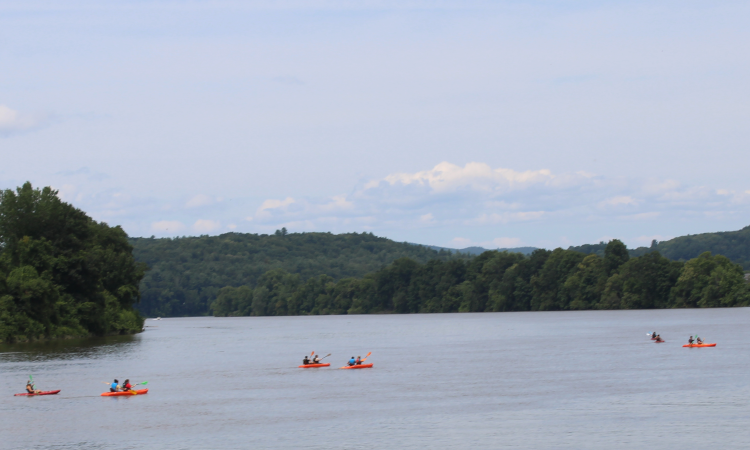 Two students in a kayak out on the open water