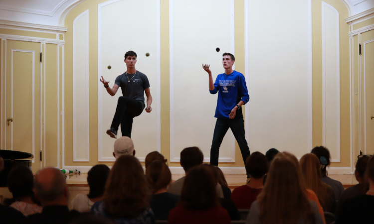 Two juggle onstage at Open Mic Night