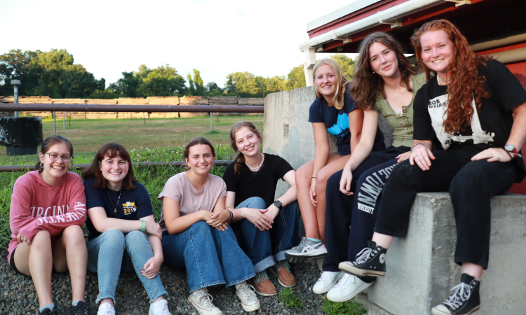 Seven pose for a photo by the snack shop at the drive-in theater