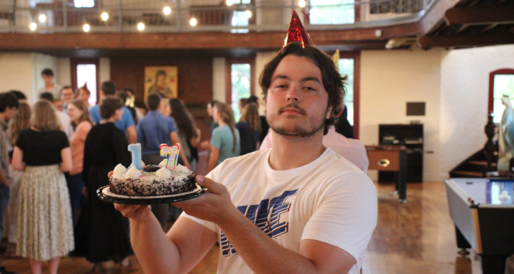 A prefect displays a cake