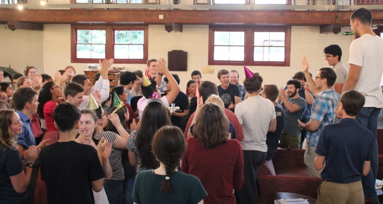 Students cheer and celebrate with party hats on