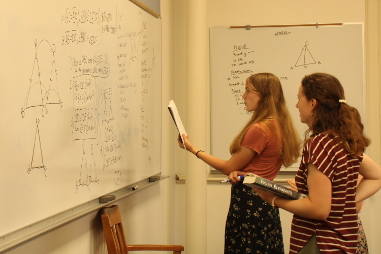 Students demonstrate a prop at the board