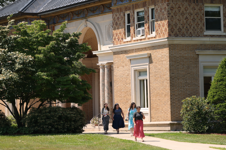 Students walk past St. Thomas More Hall