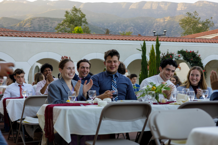 Students applaud a toast