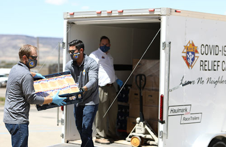 Class of 2003 classmates Jeremy Boucher (left) and Patrick Mason (right) unload a trailer of supplies / Photo: Johnny Jaffe