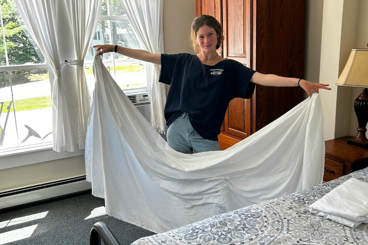 Student workers make a bed