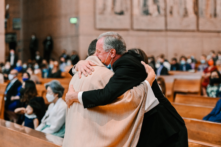 Fr. Masteller hugs his father, Quincy