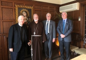 Rev. Paul Lamb (left) accompanying President Michael F. McLean and  Vice President Paul J. O’Reilly on a visit to His Eminence Seán Cardinal O’Malley, Archbishop of Boston, in 2018