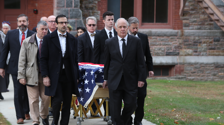 Pallbearers escort the casket from the chapel
