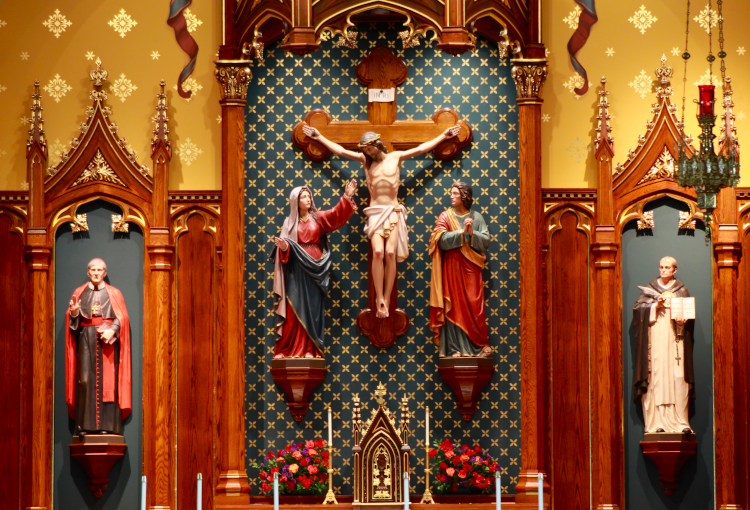 The sanctuary of Our Mother of Perpetual Help Chapel features statues of St. John Henry Newman (left) and St. Thomas Aquinas (right).