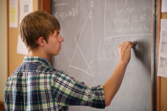 Student demonstrates a proposition on the chalkboard 