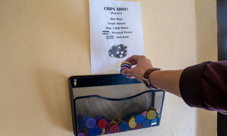 Student places prayer chip in a mailbox