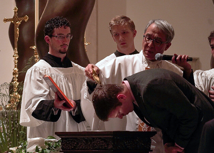 Chaplain Rev. John Mary Chung conditionally baptizes Josiah Savannah (’25) at the Easter Vigil