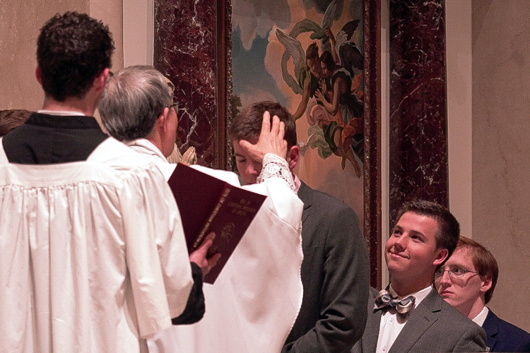 Fr. Chung confers the Sacrament of Confirmation upon Josiah at the Easter Vigil