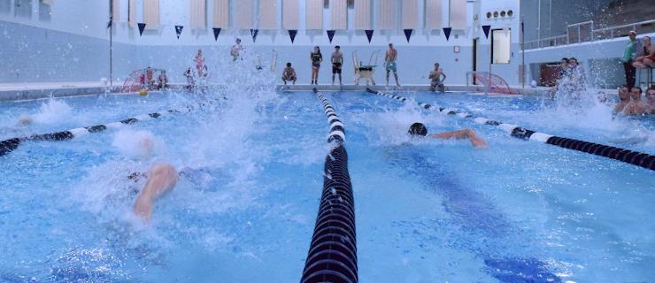 Students swim in the New England pool